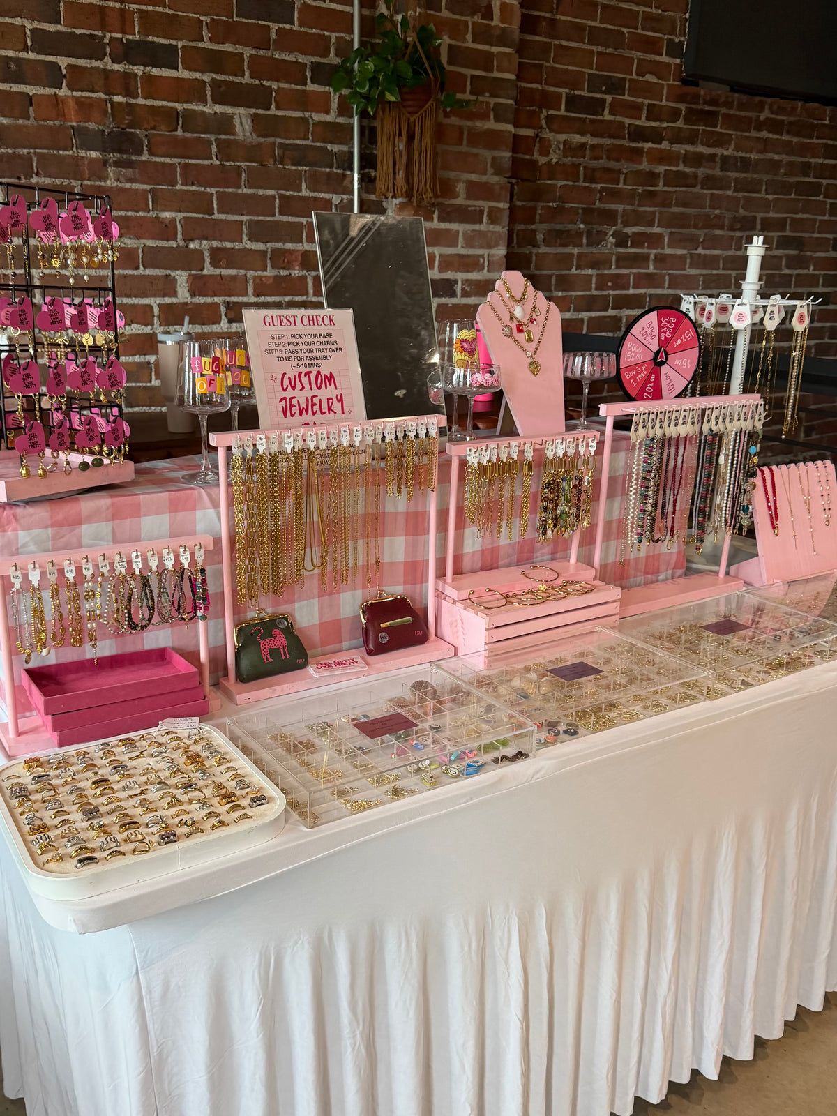 Custom jewelry charm bar pop up display table with necklaces, bracelets, and charms